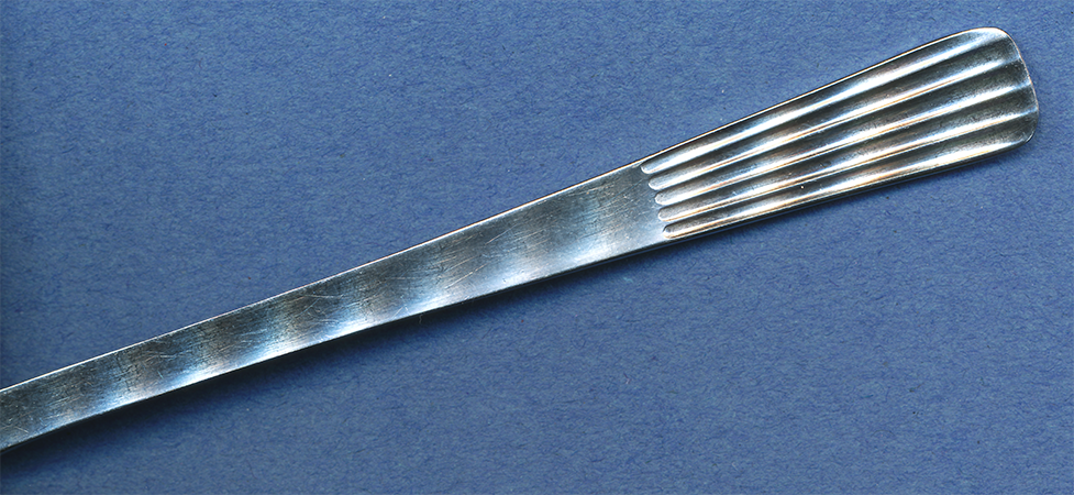 decorative tip-end of a stainless steel fork made in the DDR aka East Germany and sold in Gyor Hungary in autumn 1990